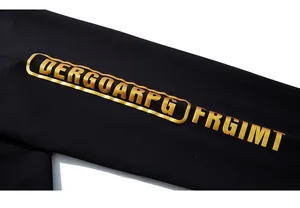 Detail of premium black cotton fabric featuring metallic gold letter print on the garment