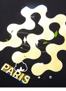Macro detail of high-quality cotton fabric and bright yellow Paris print on black hoodie