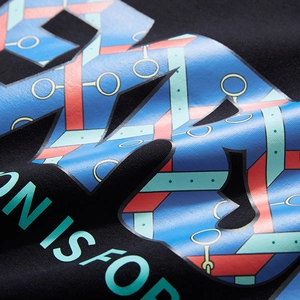 Close-up of colorful geometric letter print on black oversized men's cotton hoodie