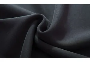 Close-up of thick dark grey knitted fabric showing soft texture and premium quality
