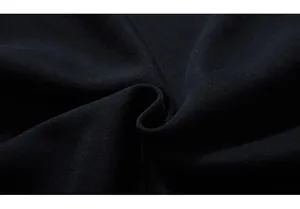 Close-up of high-density black knit fabric with detailed texture and soft shadow