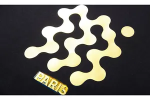 Macro detail of the gold foil Paris print on a black cotton oversized sweatshirt