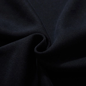 Close-up of black oversized sweatshirt fabric showing detailed soft cotton texture