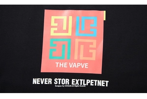 Detail of colorful geometric graphic print and typography on a black oversized t-shirt