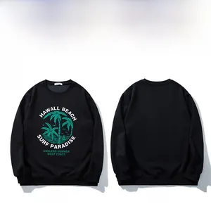 Detail of black long-sleeve sweatshirt featuring green palm tree print and ribbed cuffs