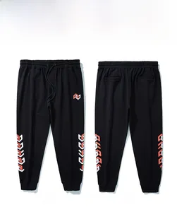 Detail view showing front and back of black joggers with geometric red and white print