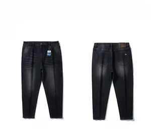 Detailed front and back views of gray-black denim jeans with leather patch and embroidery