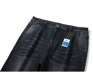 Detailed close-up of dark grey washed denim waist with YKK tag and metallic button