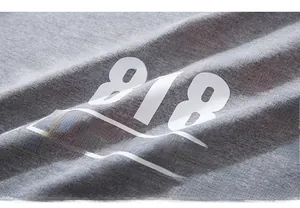 Close-up of vintage 818 graphic print and cotton fabric texture on grey t-shirt