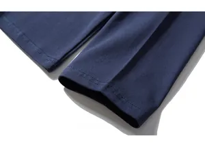 Detailed macro view of dark blue knit fabric with durable double-stitched reinforced seams