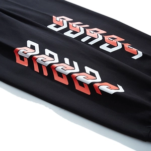 Men's baggy joggers in black with bold red and white geometric graphic print on the leg