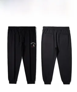 Front and back view of men's black joggers with wolf embroidery and elastic cuffs
