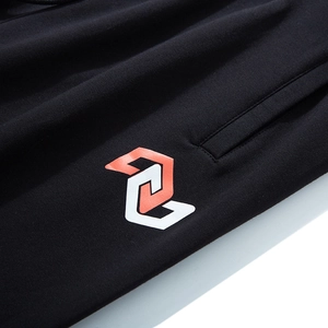 Men's loose black joggers with orange geometric print and elastic waist sport design