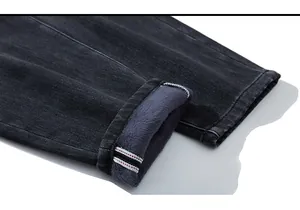 Detail of grey winter jeans featuring warm fleece lining and red selvedge denim cuffs