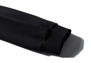 Detail of black sweatshirt ribbed cuff showing premium stitching and fabric texture