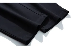 Detail shot of the black men's sweatpants leg cuff with durable double-stitched flat seams