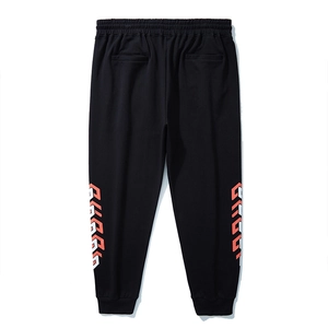 Black joggers with elastic waist and orange geometric print on the back lower legs