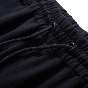 Men's plus size black sports pants featuring an elastic drawstring waistband with metal eyelets