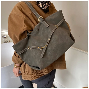 Detail of dark olive green tote bag with matte finish and adjustable metal buckle strap