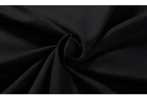 Detailed macro shot of high-density black knit fabric texture for cotton oversized t-shirt