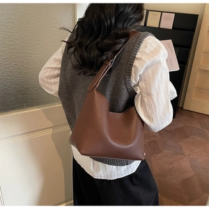 Detailed back view of a brown lychee pattern leather hobo bag with adjustable shoulder strap