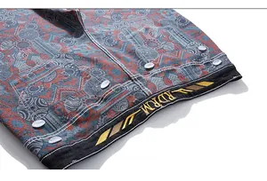 Detailed embroidery of RDRM logo and ethnic patterns on blue denim pants waistline