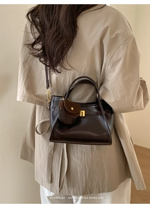 Deep brown retro tote bag styled with a beige shirt for a minimalist commuter look