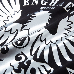 Loose black cotton T-shirt featuring a large silver metallic eagle print and logo