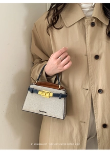 Detail of canvas handbag with leather trim, metal twist lock and Pantor brand logo