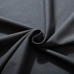 Close-up of charcoal grey fabric showing fine woven texture and smooth drape on oversized T-shirt