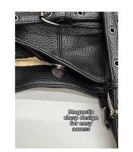 Detail of black litchi grain leather tote with silver magnetic buckle and metal eyelets