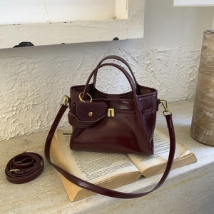 Detail of vintage burgundy faux leather handbag with matching small coin purse attachment