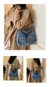 Detailed close-up of blue denim hobo bag featuring metal zippers and utility pockets