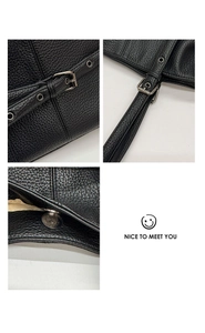 Detailed view of black litchi pattern leather texture and silver metal buckle hardware