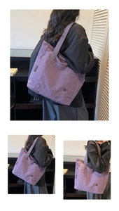 Detail view of purple canvas tote bag featuring CHUANGMI side label and exterior pocket