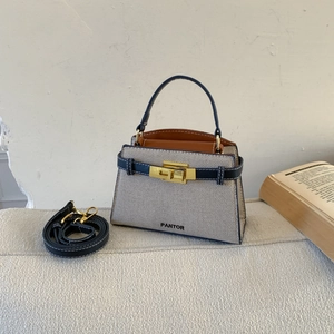 Chic grey canvas and navy leather tote bag with gold buckle and adjustable strap