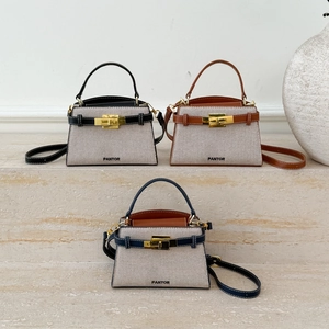 Elegant canvas and leather crossbody handbags in black, brown, and navy blue variants