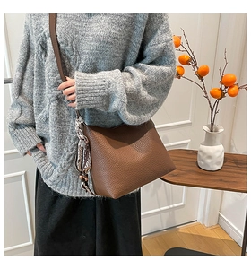 Brown litchi grain leather shoulder bag with decorative silk scarf and soft texture