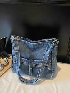 Retro washed blue denim tote bag with multi-pocket design and adjustable shoulder strap