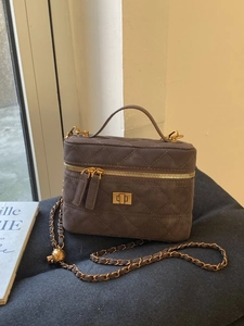 Quilted gray mini crossbody bag with golden ball adjustable chain strap and top handle