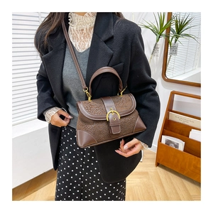 Brown leopard print crossbody bag styled on a model in a natural indoor setting