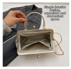 Macro view of Chinese embroidery bag interior with golden metal handle and pocket