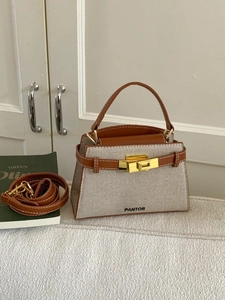 Minimalist beige canvas and brown leather trapezoid handbag with gold twist lock