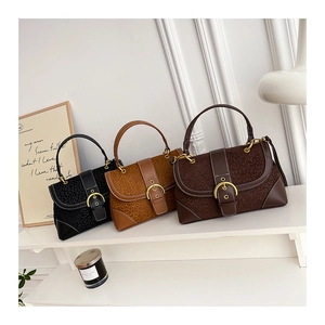 Detail of retro saddle bags with leopard texture, metal buckles and fine stitching