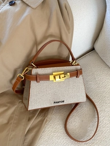 Minimalist canvas and leather trapezoid tote bag with PANTOR logo and gold hardware
