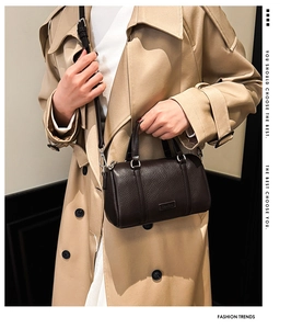 Close-up of dark brown lychee leather Boston bag with silver hardware and shoulder strap