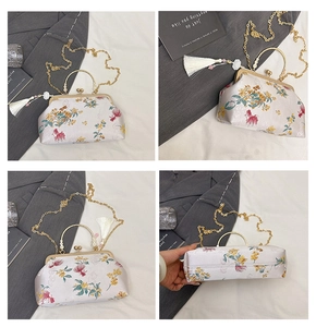 Detail of lavender satin evening bag with floral embroidery and golden metal ring handle