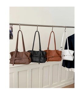 Litchi pattern faux leather shoulder bags in four colors displayed on metal hooks