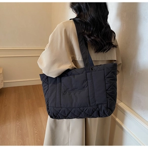 Rear view of black quilted tote bag with Gugugugu embroidery and large capacity