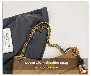 Detail of woven chain strap and quilted leather texture on brown retro shoulder bag